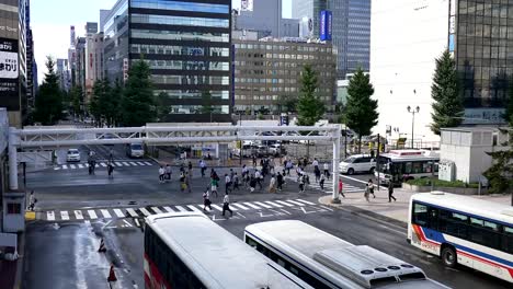 Wide-shot-of-people-walking-at-a-busy-cross-road-junction
