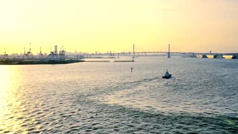 wide-shot-of-the-busy-Japan-yokohama-bridge,-guide-boat,-port-area,--light-house