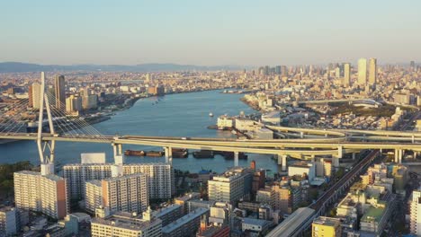 Aerial-view-over-Osaka-port-and-Tempozan-Giant-ferris-wheel,-Hanshin-Expressway,-Aji-river-and-Yodo-river-with-Osaka-city-in-background.