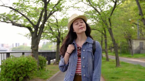 woman-walking-in-the-park-near-the-river