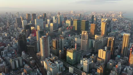 Aerial-view-over-Osaka-city-with-many-skyscrapers-in-the-morning.-Osaka-is-the-capital-city-of-Osaka-Prefecture,-the-second-largest-metropolitan-area-in-Japan.