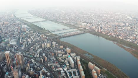 Aerial-view-over-Osaka-city-with-many-skyscrapers-in-the-morning.-Osaka-is-the-capital-city-of-Osaka-Prefecture,-the-second-largest-metropolitan-area-in-Japan.