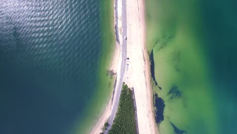 Aerial-view-of-long-road-between-sea-shore