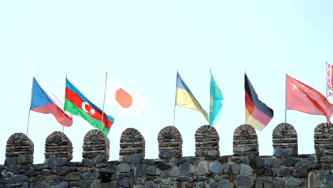 Czech-Azerbaijani-Japanese-Ukrainian-Kazakh-German-Chinese-Flags-on-fortress-wall