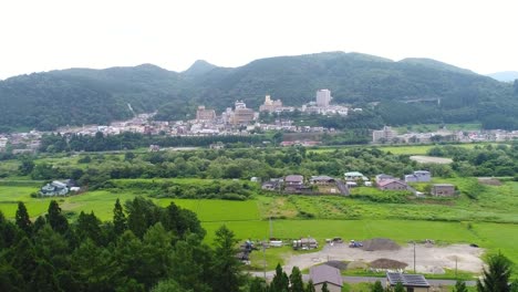 Drayne-aerial-photography-of-the-Naruko-Onsen-and-rice-fields-in-Osaki,-Miyagi-Prefecture,-Japan-in-the-summer-of-2017