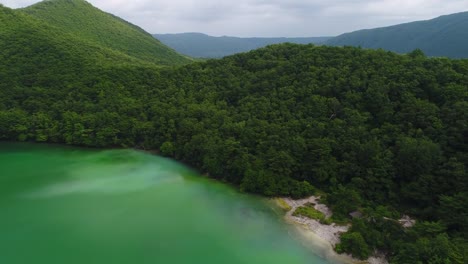 Dolong-aerial-photography-of-the-lake-and-mountains-of-Osaki-city,-Miyagi-prefecture,-Japan-in-the-summer-of-2017