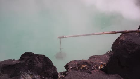 Hierve-agua-caliente-de-termales-en-la-montaña-con-árboles-de-Japón,-piscinas-de-agua-caliente,-vapor-lodo-hirviendo-sobre-la-parte-superior-del-estanque-inundación-géiser.-Caldero-de-azufre-Dan