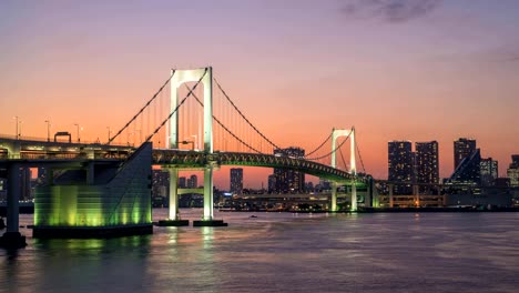 Día-Tokyo-puesta-del-sol-ciudad-horizonte-timelapse-de-la-noche-en-el-puente-del-arco-iris,-Odaiba,-lapso-de-tiempo-de-4K-de-Tokio,-Japón