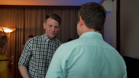 Two-smiling-male-talking-while-drinking-champagne