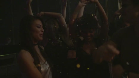 Group-of-friends-dancing-at-nightclub-with-confetti