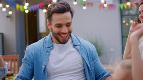 Handsome-Young-Man-Dances-Together-with-Family-and-Friends-at-the-Garden-Party-Celebration.-Young-and-Elderly-People-Having-Fun-on-a-Sunny-Summer-Day-Disco.