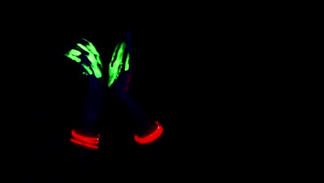 Glowing-hand-dancing-movement-in-black-background,-green-glowing-paint.-Women.