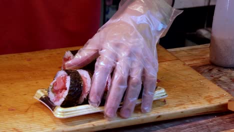 close-up-of-a-chef-serving-sushi-at-tsukiji-fish-market