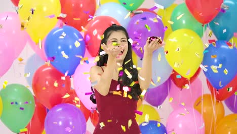 Beautiful-asian-woman-dancing-with-happy-emotion-with-colorful-balloon-background-at-the-party-in-slow-motion.