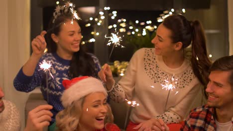 happy-friends-with-sparklers-celebrating-christmas-at-home-party