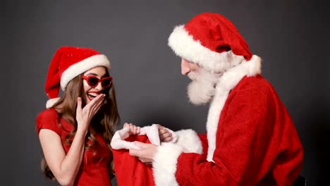 Santa-Gives-Bags-with-Presents-to-Girl