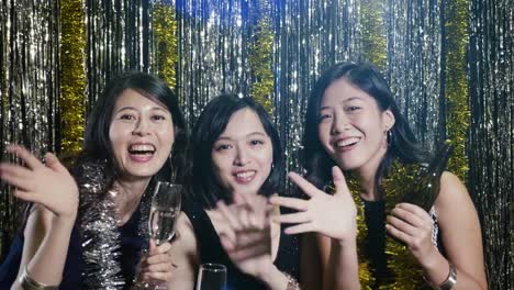 asian-women-face-camera-waving-hands-cheerfully