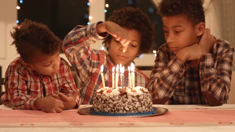 Boy-count-candles-on-the-cake.