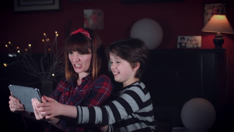 4k-Family-Home-Shot-of-Child-with-Mum-Having-Fun-Playing-on-Tablet-Video-Game