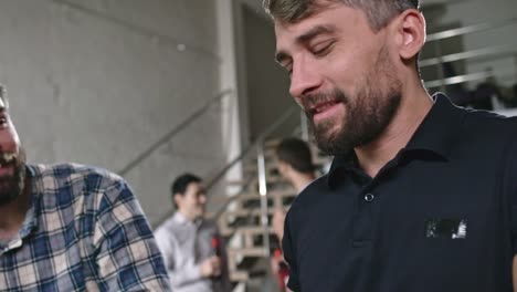 Male-Friends-Joking-and-Chatting-while-Preparing-Salad