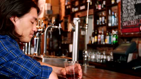 Depressed-man-having-whisky-at-bar-counter