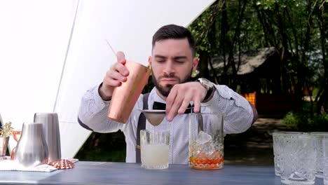 Barkeeper-Gießen-langsam-Likör-in-vorbereiteten-Weinglas-bar-Arbeiter-durch-Filter-cocktail-Zubereitung