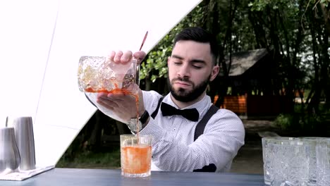 Barkeeper-gießt-Glas-in-vorbereiteten-Weinglas-mit-Likör,-bar-Arbeiter-Vorbereitung-cocktail-mischen