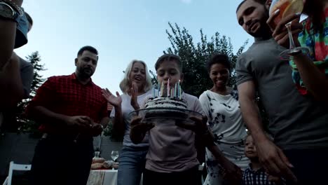 Boy-blowing-candles-on-cake