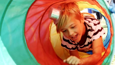 Boy-moving-through-tent-tunnel-4k