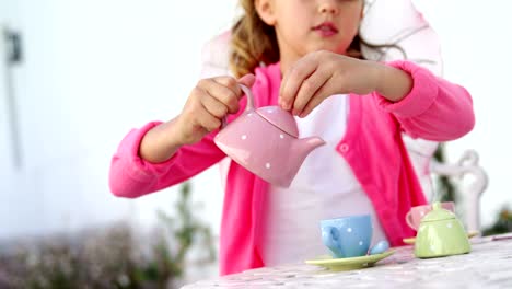 Girl-in-fairy-costume-pouring-tea-into-cup-4k