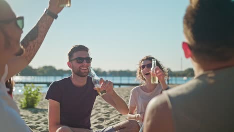 Junge-Menschen-klirrende-Flaschen-am-Strand