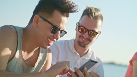 Young-People-Having-Fun-on-the-Beach-Using-Phones