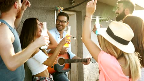 Group-of-happy-friends-having-party-on-rooftop