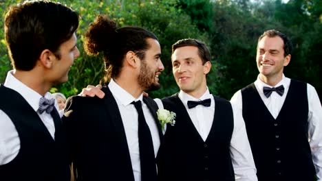 Groom-and-groomsmen-happily-talking-with-each-other-4K-4k