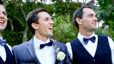 Groom-and-groomsmen-happily-hugging,-talking-4K-4k