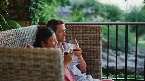 Couple-Enjoying-Glass-of-Wine-at-Luxury-Resort