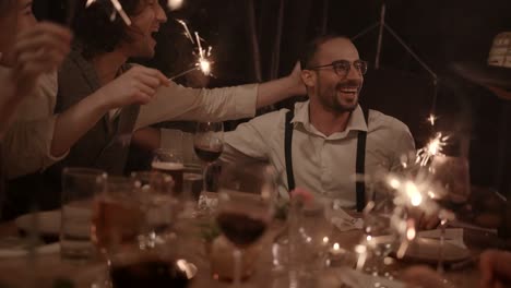 Young-multi-ethnic-friends-celebrating-man's-birthday-at-gourmet-dinner-party