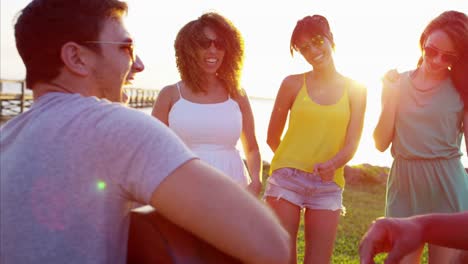 Multi-ethnic-males-and-females-enjoying-beach-holiday