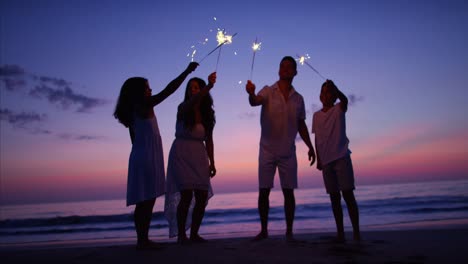 Silhouette-of-Spanish-family-on-beach-with-sparklers