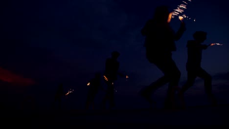 Partying-teens-enjoying-their-time-together-with-fireworks-after-sunset