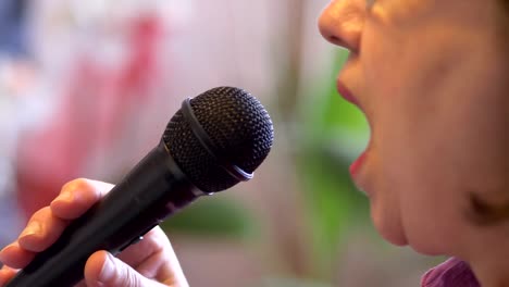 Senior-woman-signing-with-microphone-karaoke-in-slow-motion-4k-slow-motion