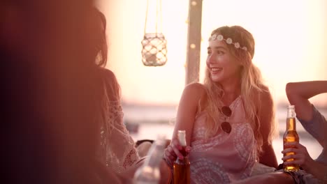 Young-friends-at-summer-island-beach-bar-drinking-beer