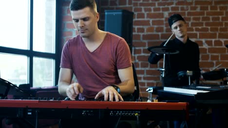 Men-playing-musical-instruments-in-studio