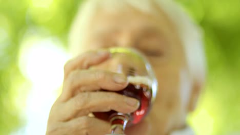 Mature-woman-drinking-red-wine