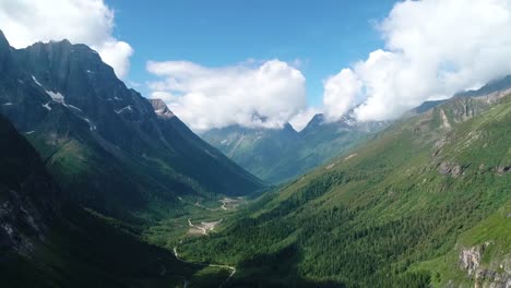 drone-flying-in-the-gorge-with-snow-mountain-and-pine-forest