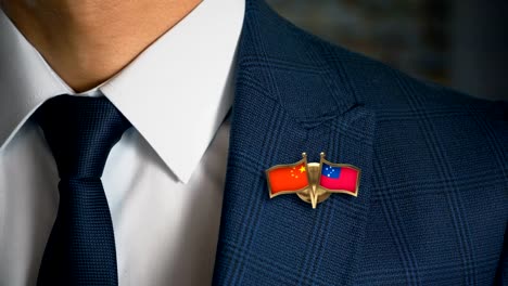 Businessman-Walking-Towards-Camera-With-Friend-Country-Flags-Pin-China---Samoa