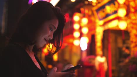 Young-Chinese-woman-using-phone-in-street