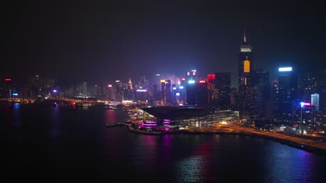 night-time-illuminated-hong-kong-city-downtown-traffic-bay-aerial-panorama-4k