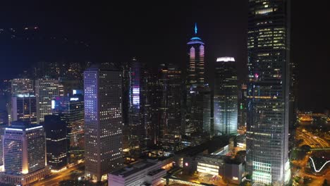 noche-iluminada-hong-kong-ciudad-Centro-Bahía-aérea-panorama-4k