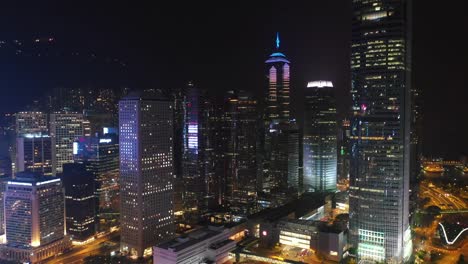 night-time-illuminated-hong-kong-city-downtown-bay-aerial-panorama-4k